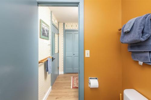 a bathroom with a blue door and a hallway at Alyeska Retreat C110 in Girdwood