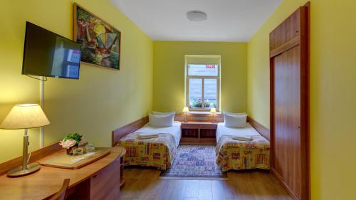 a small room with two beds and a window at In Astra in Vilnius