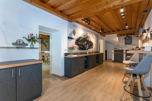 an open kitchen with wooden ceilings and wooden floors at Hotel Landhaus Lungau in Sankt Michael im Lungau