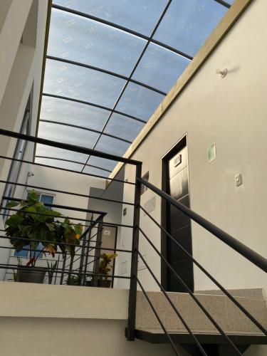 a stairway with a glass ceiling and a window at CasaBlanca ApartaEstudios in Girardot