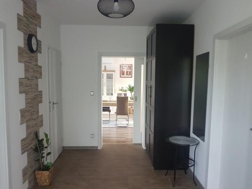 a hallway with white walls and a black cabinet at Ubytování U Špačků Pálava in Novosedly