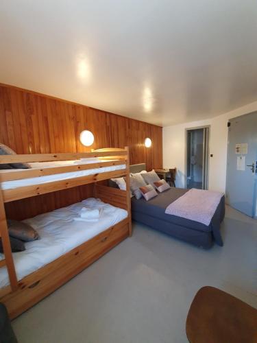 a bedroom with two bunk beds in a room at Hotel L'envie des mets in Lus-la-Croix-Haute