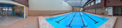 a large swimming pool in a large building at Wollongong Surf Leisure Resort in Wollongong