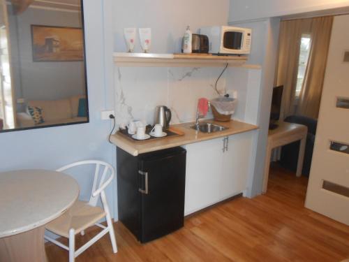 a small kitchen with a sink and a table at Mount View Motel in Bulahdelah