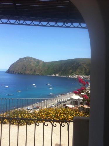 a view of a beach and the ocean from a balcony at Oltremare Residence Hotel in Lipari
