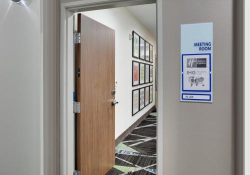 a hallway with a door with a sign on it at Holiday Inn Express & Suites San Antonio NW near SeaWorld by IHG in San Antonio