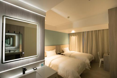 Ένα ή περισσότερα κρεβάτια σε δωμάτιο στο Beijing Saga Hotel
