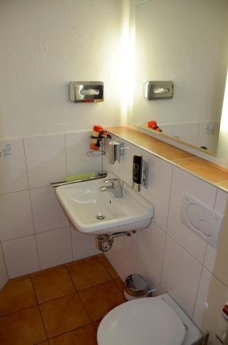 a bathroom with a white sink and a toilet at Gasthof zur Traube in Bühl