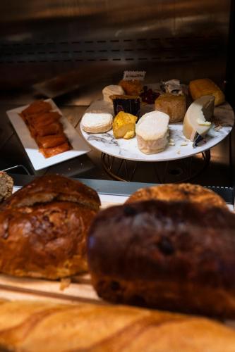 two plates of bread and pastries on a table at Hôtel Merveilleux Côté Mer in Dunkerque