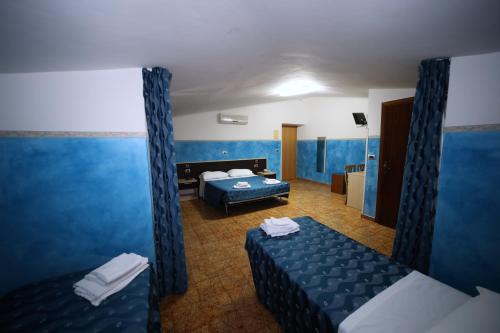 Postel nebo postele na pokoji v ubytování Hotel Napoleone