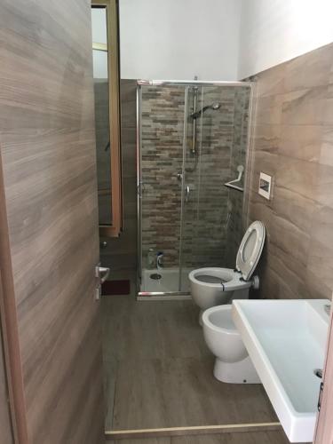 a bathroom with a toilet and a shower and a sink at Terrazza sul mare - Villa Tota - in Ardore Marina