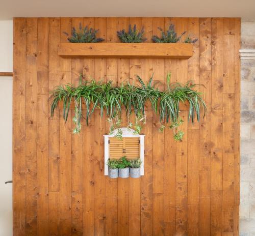 a wooden fence with potted plants on it at Parthenon Rooms in Koroni