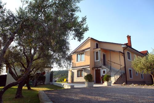 a house with a tree in front of it at Residence Villa Fiore Portorož in Portorož