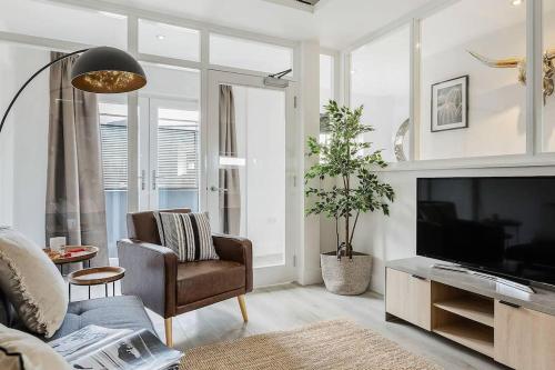 a living room with a television and a couch and a chair at Host & Stay - Slater Street Apartments in Liverpool