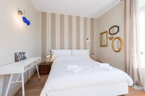 a white bedroom with a white bed and a desk at Villa Rocky - Luxury 3BR Apt in Liberty Villa.Pool,Garden,WiFi in Roquebrune-Cap-Martin