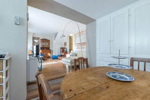 a kitchen and dining room with a wooden table and chairs at Villa Rocky - Luxury 3BR Apt in Liberty Villa.Pool,Garden,WiFi in Roquebrune-Cap-Martin