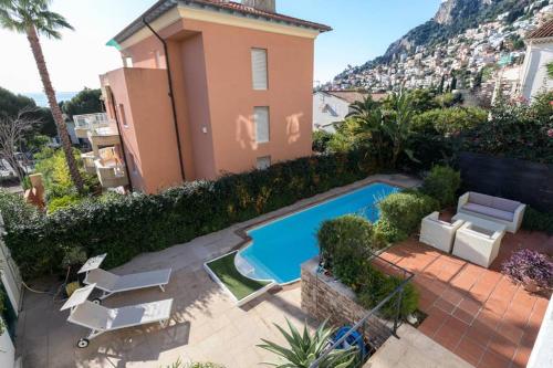 a villa with a swimming pool and a house at Villa Rocky - Luxury 3BR Apt in Liberty Villa.Pool,Garden,WiFi in Roquebrune-Cap-Martin