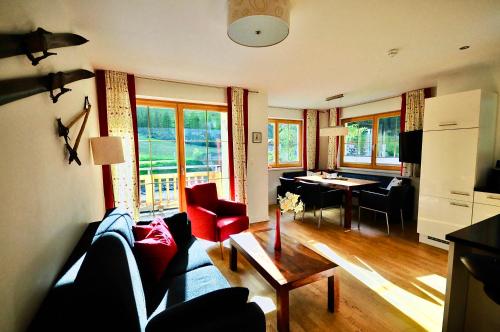 a living room with a couch and a table at A Casa Residenz in Sölden