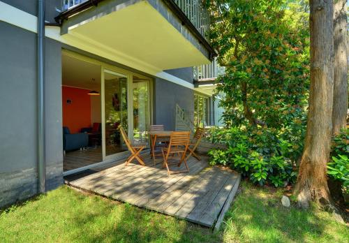 a patio with a table and chairs on a porch at Apartamenty Sun Seasons 24 - Willa Laser in Szklarska Poręba