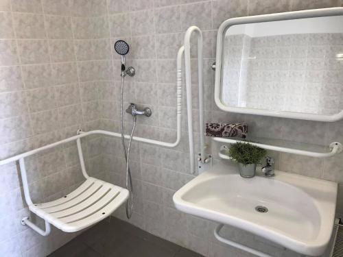 a white toilet sitting next to a bath tub in a bathroom at Hostel Masarykova in Prague