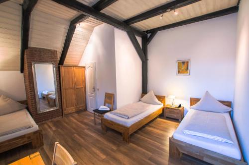 a room with two beds and a mirror at Hotel Ovelgönner Hof in Buxtehude