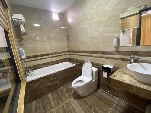 a bathroom with a toilet and a sink at MV Hotel in Hai Phong