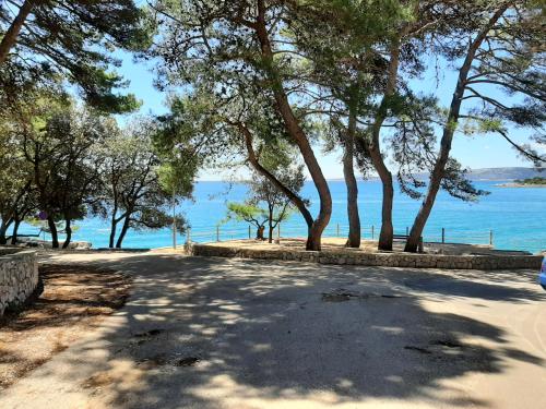 a road with trees and a view of the water at Ferienwohnung KRK Peter Lindpointner in Krk