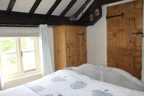 a bedroom with a white bed and a window at Munden House in Sherborne