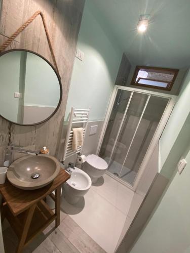 a bathroom with a sink and a toilet and a mirror at Le volte nel borgo in Termoli
