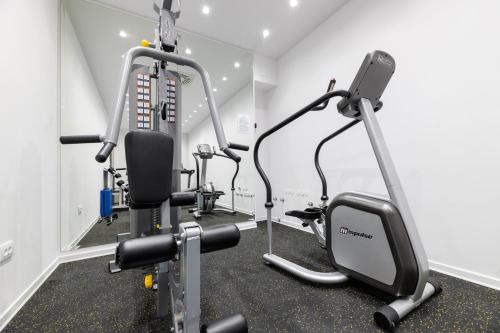 a gym with two tread machines in a room at BO Hotel Palazzo in Poreč