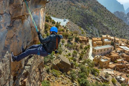 a man is rappelling down a mountain at Sahab Resort and Spa, Jabal Al Akhdar in Al ‘Aqar