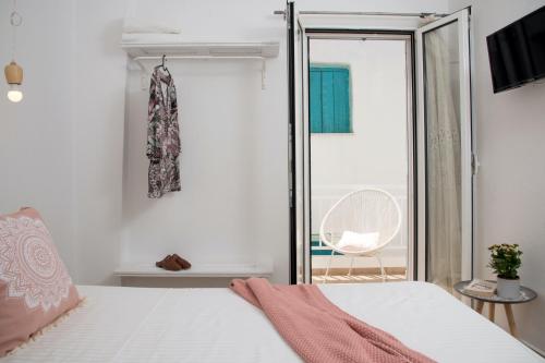 a bedroom with a bed and a sliding glass door at Unique Anoi House - In the Heart of Skyros Village in Skiros