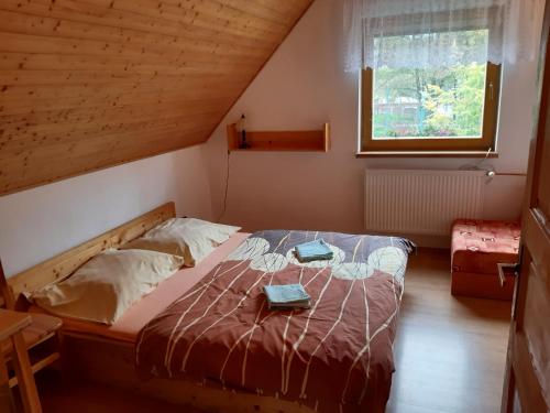 a bedroom with a bed with two folders on it at Apartmány Jarmila in Dolní Moravice