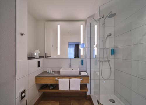 a bathroom with a sink and a shower at Hotel Restaurant Burg-Klause in Burg auf Fehmarn