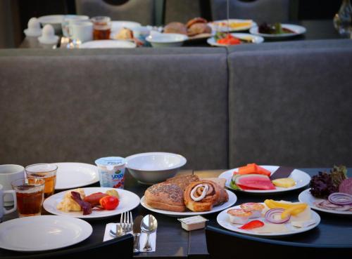a table with plates of food on it at Taastrup Park Hotel in Tåstrup