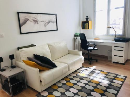 a living room with a white couch and a desk at 1min walk to Casino of Monaco in Monte Carlo
