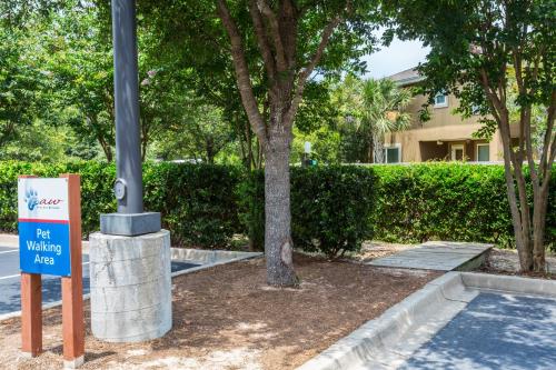 a sign in front of a building with a tree at Candlewood Suites Destin-Sandestin Area by IHG in Destin