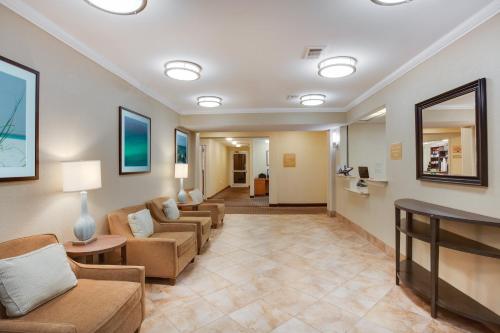 a living room with couches and a waiting room at Candlewood Suites Destin-Sandestin Area by IHG in Destin