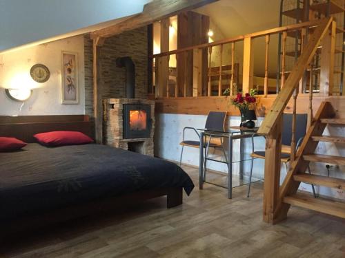 a bedroom with a bed and a staircase and a desk at Sea Rooms ENGURE in Engure