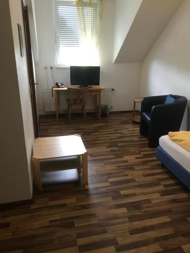 a living room with a couch and a table at Hotel Kaufmann in Rommerskirchen