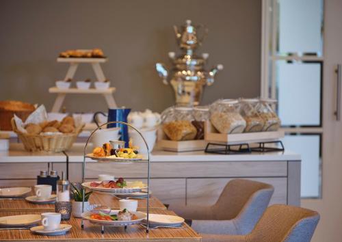a table with a tray of food on a buffet at Hotel Restaurant Burg-Klause in Burg auf Fehmarn