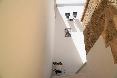 a stairway with two lights and a potted plant at Corte San Vincenzo in Ugento