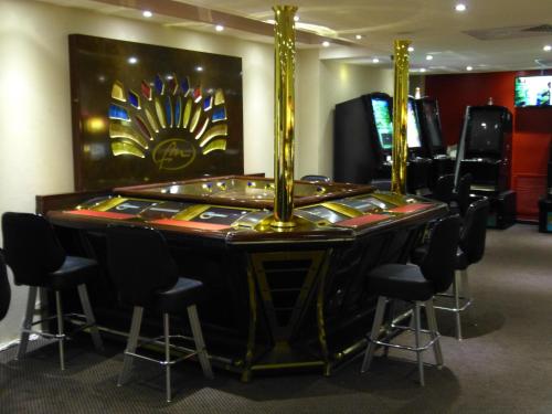 a poker table in a room with chairs at Savoy Hotel Boutique in Las Terrenas