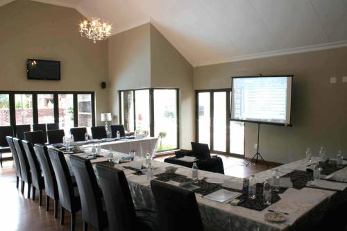 a large meeting room with a long table and chairs at Kathu Gamagara Lodge in Kathu