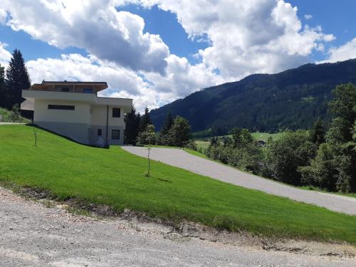 a house on a hill with a road at Haus Holzmann in Radstadt
