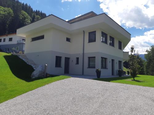 a large white house with a driveway at Haus Holzmann in Radstadt