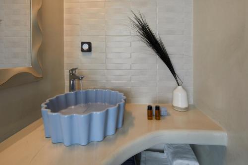a bathroom with a blue bowl on a counter at Blue Sea Hotel in Kamari