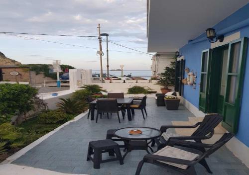 a patio with chairs and tables and a table at Rosa Dei Venti Ponza in Ponza