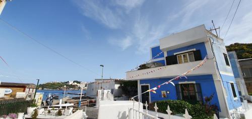 a blue and white building with a fence at Rosa Dei Venti Ponza in Ponza