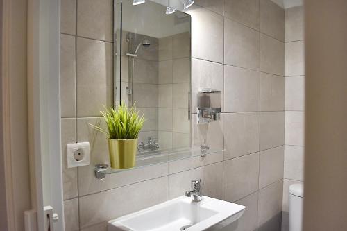 a bathroom with a sink and a mirror at Check Point - Acropolis in Athens